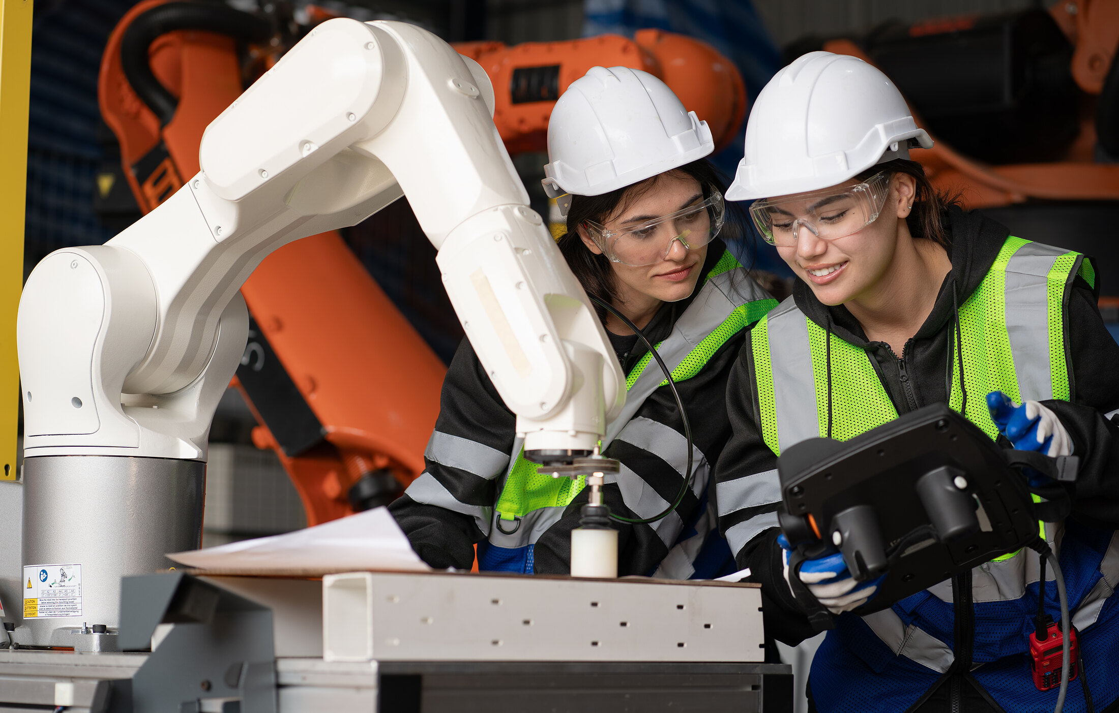 Two engineers checking their work at a build station.