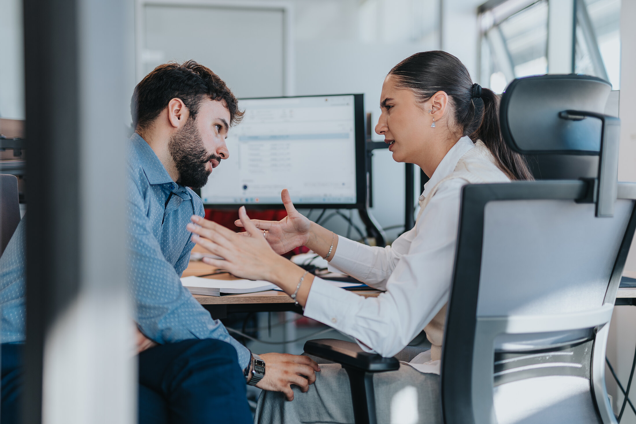 Two people working through a draft, mid-argument over a line.