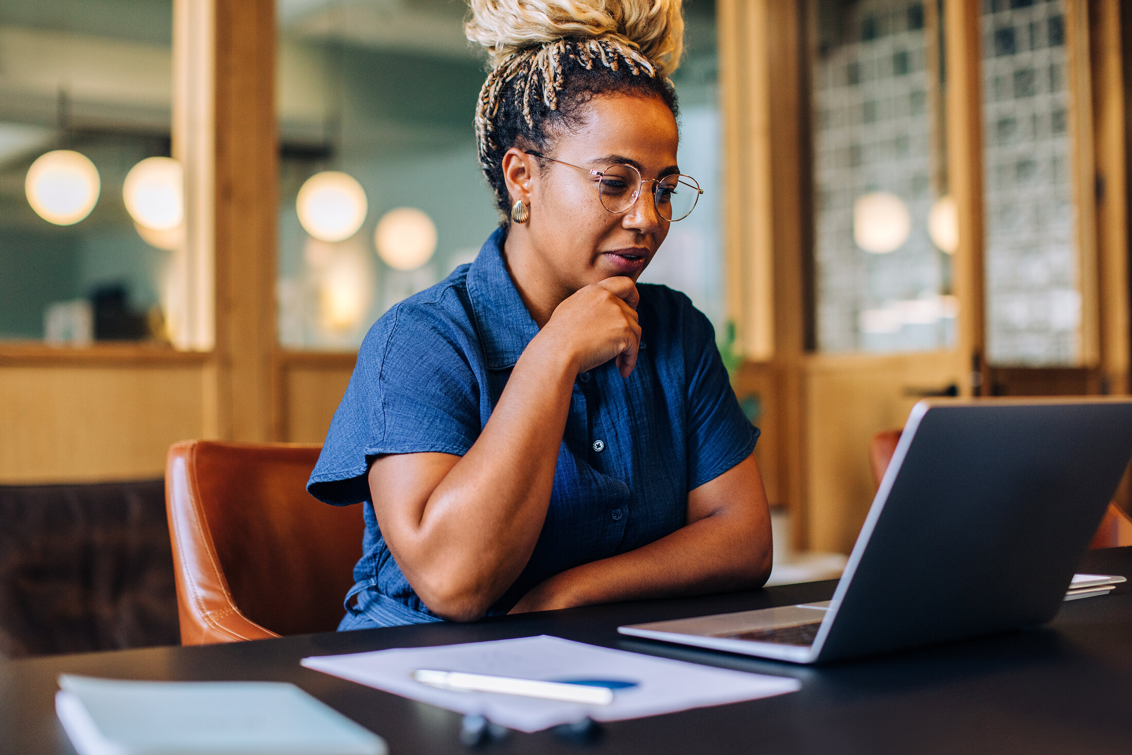 A founder working a live bid at her laptop.